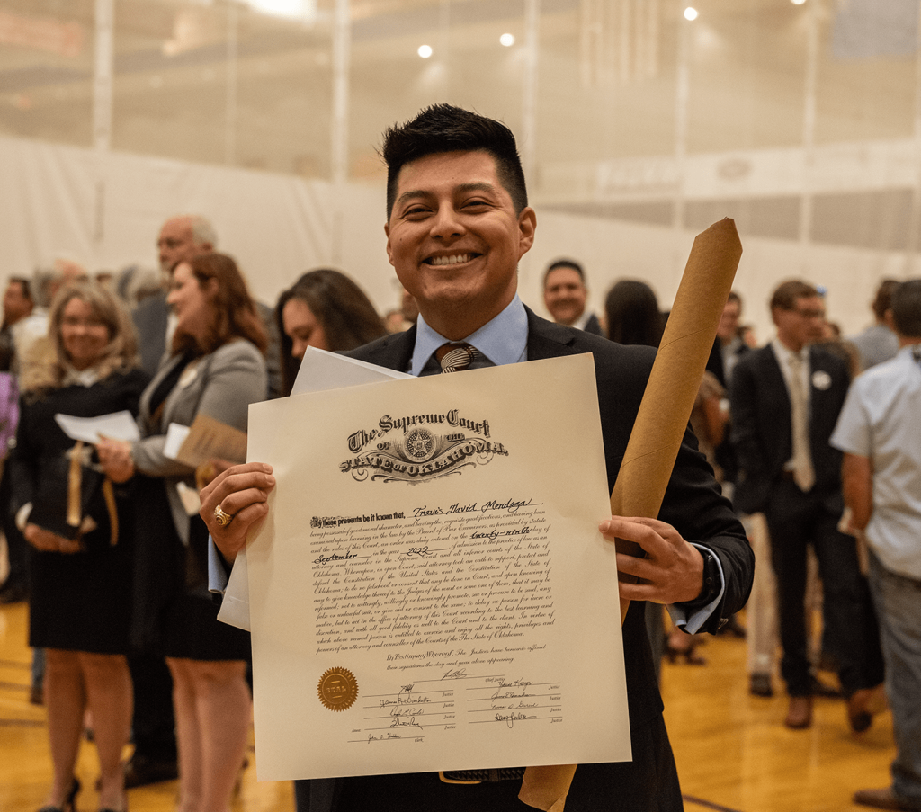 Travis Mendoza displays his wall certificate.